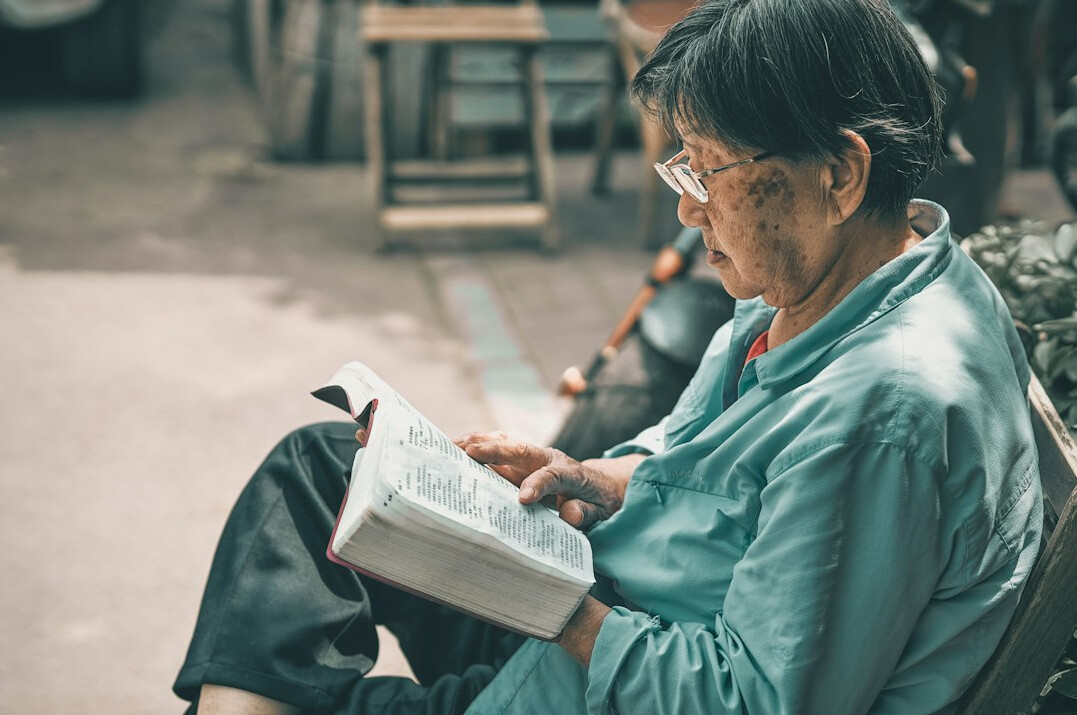 elderly woman reading book