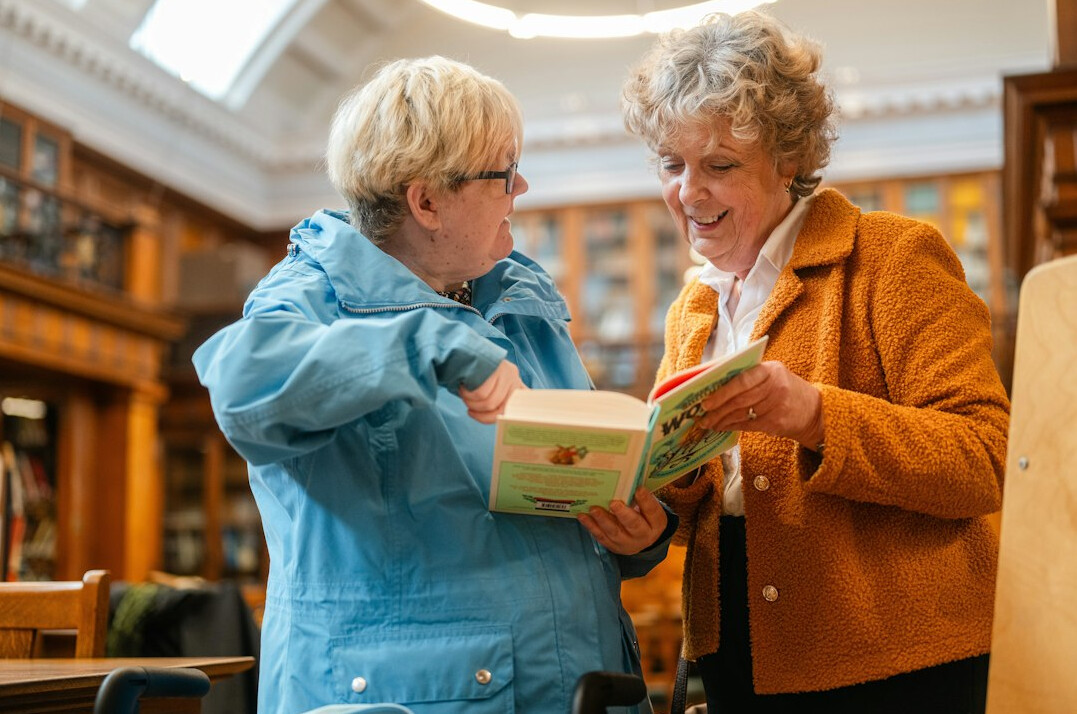 senior woman reading book in club